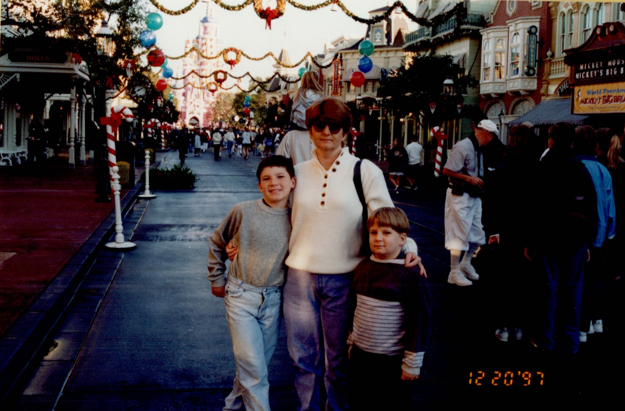 Luke, his brother and mom at Disney World. It is timestamped 1997.
